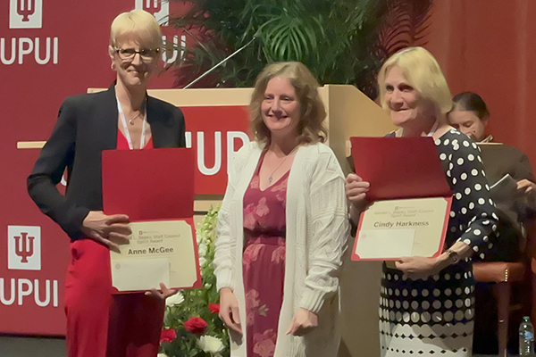 Anne McGee holding her Bepko Award with Heather Staggs and Cindy Harkness