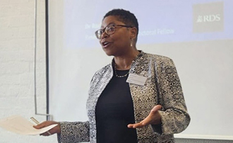 a woman gestures while speaking