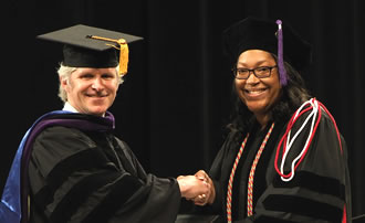 Vice DeanPage shakes hands with Faculty Prize recipient Kristina Coleman