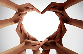 Different colored hands making the shape of heart