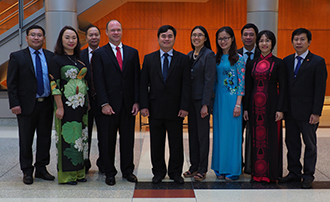 Members of the delegation from the Ho Chi Minh Academy of Politics visit with IU McKinney Dean Andrew R. Klein and Professor Xuan-Thao Nguyen