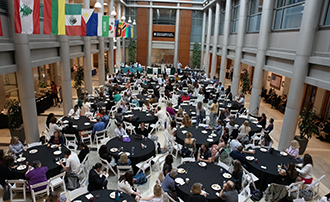 people sitting at tables in the atrium at Inlow Hall