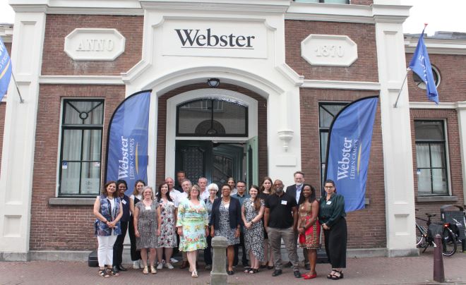 Dean Karen Bravo (center) with faculty at a conference in Amsterdam