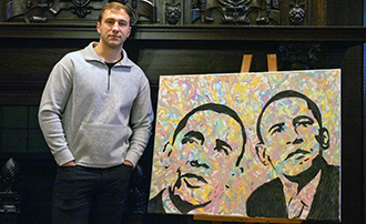 man standing next to a painting he created