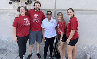 five people stand together near the downtown Indianapolis canal