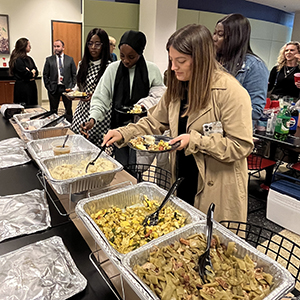 Students getting Thanksgiving food in a buffet line in the cafeteria