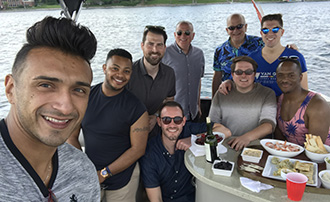 alumni and students on a boat