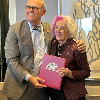 Judge Mark Pfeiffer presents an award to Judge Margret Robb