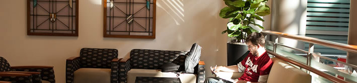 Male student reading.